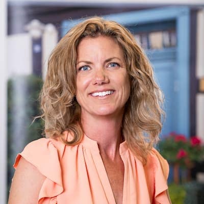 Erin Griffin smiling outdoors, promoting mortgage and loan services at Preferred Rate.