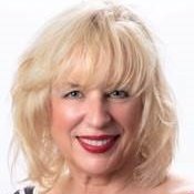 Portrait of Peggy Ann Valley, smiling woman with blonde hair.