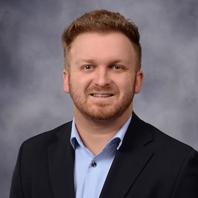 Joe Bandenburg smiling in professional headshot for financial services.