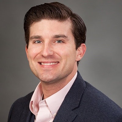 Eric William Stone smiling, professional headshot for financial services.