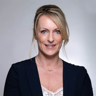 Julie Johnson smiling, professional portrait for mortgage and loan services.