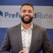 Financial advisor smiling in front of Preferred Rate logo, promoting mortgage and loan services.