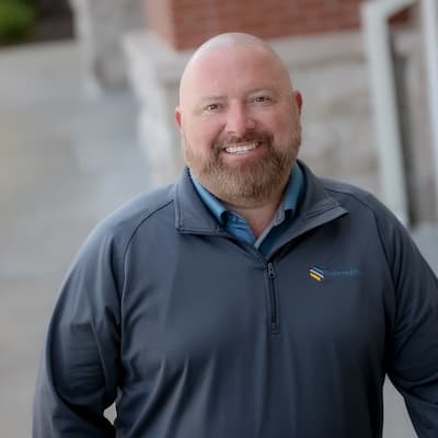 Jim Decker smiling outdoors, representing Preferred Rate's trusted financial services.