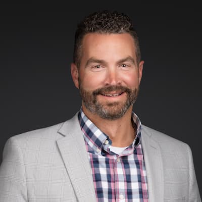 Portrait of Matthew R. Davis, financial expert, smiling in business attire.