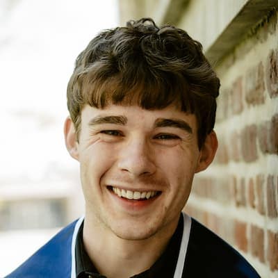 Kyle O'Malley smiling outdoors, showcasing a friendly and approachable demeanor.