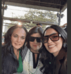 Group of women enjoying a social event, smiling and wearing sunglasses.