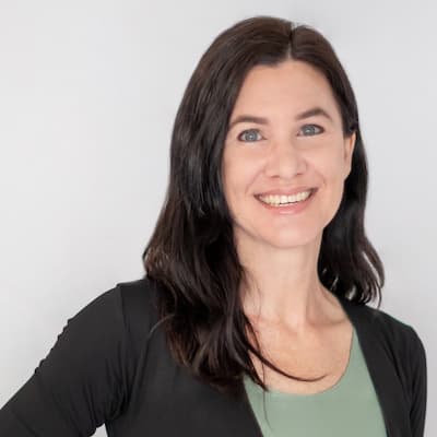 Lori Harges smiling, professional portrait for financial services.