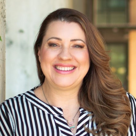 Professional woman smiling, representing trusted financial and loan services at Preferred Rate.