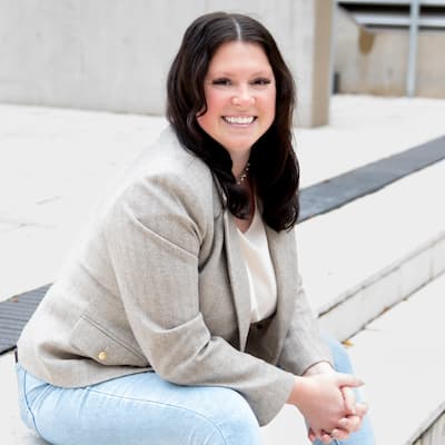 EllenGrace Hauenstein smiling outdoors, promoting financial solutions at Preferred Rate.