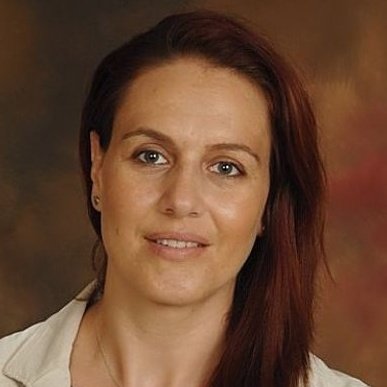 Portrait of Oana R. Farcas, professional woman for Preferred Rate.