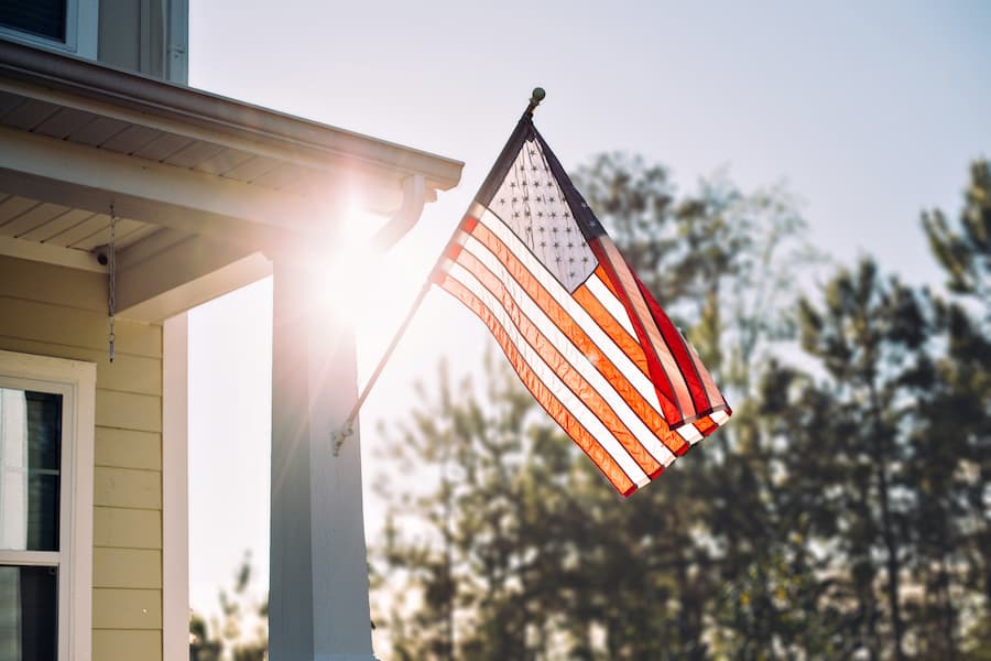 House American Flag Backlit Outside Home Blurred background (1)
