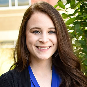 Brooke McCarty smiling outdoors, promoting financial solutions with Preferred Rate.