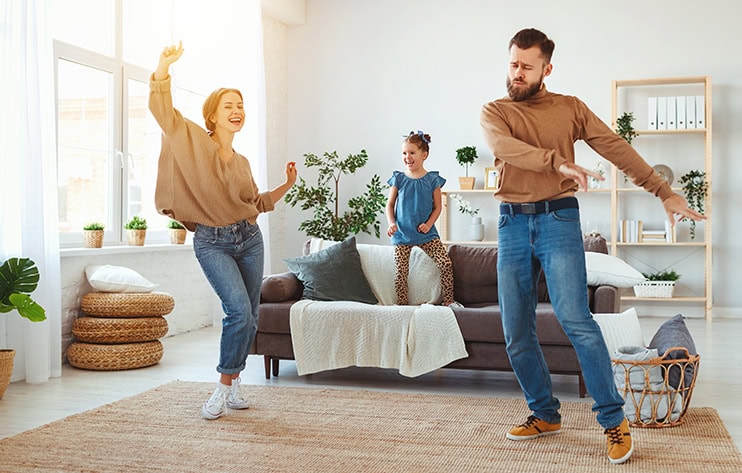 Family celebrating savings from an extra mortgage payment at home.