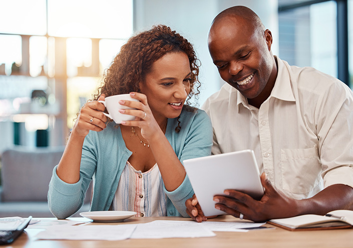 Happy couple, tablet and planning for finance, budget or application for loan on fintech app in home. Black man, woman or reading on touchscreen ux with smile, financial goals and investment profit