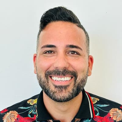 Portrait of Dash Blanco, smiling man with dark hair and beard.