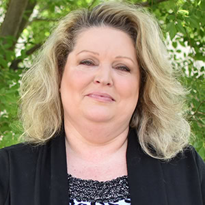 Portrait of Staci Russell, smiling woman outdoors for Preferred Rate.