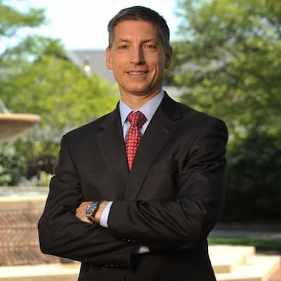 Scott Pomerich smiling confidently in a suit, representing Preferred Rate services.