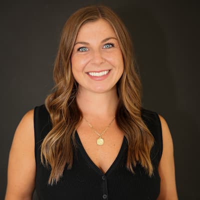 Professional woman smiling for the camera, representing trusted financial services.