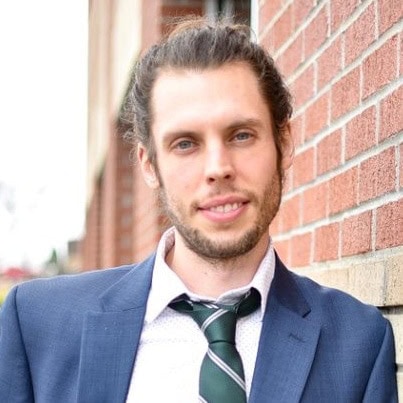 Johnny Whitfield in a professional suit outdoors.