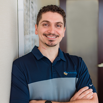 Friendly Preferred Rate representative smiling with arms crossed.