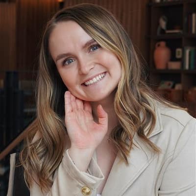 Portrait of Lauryn Ann DeShane, smiling woman with long blonde hair.