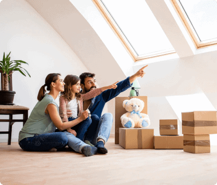 Family planning new home move, sitting on floor with moving boxes and teddy bear under skylight.
