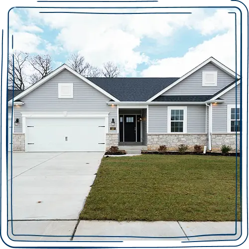House with white siding, black roof, and attached garage.